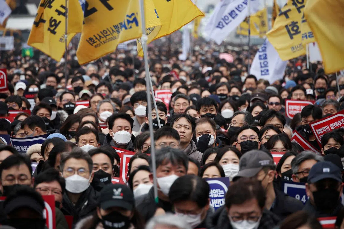 FILE PHOTO: Doctors take part in a rally to protest against government plans to increase medical school admissions in Seoul, South Korea, March 3, 2024. REUTERS/Kim Hong-Ji/File Photo