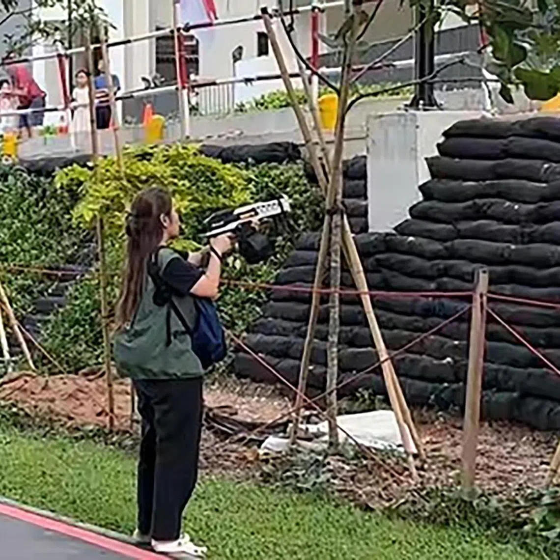 An NParks contractor using water gel blasters to drive the monkeys out of a HDB estate in Punggol on Aug 2.