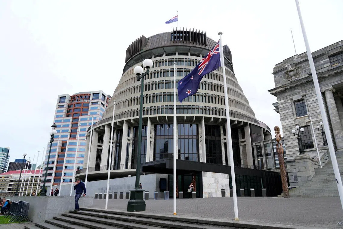 FILE PHOTO: New Zealand's flag flutters in front of 'The Beehive', the executive wing of the New Zealand Parliament Buildings, in Wellington, New Zealand, September 24, 2025. REUTERS/Marty Melville/File Photo