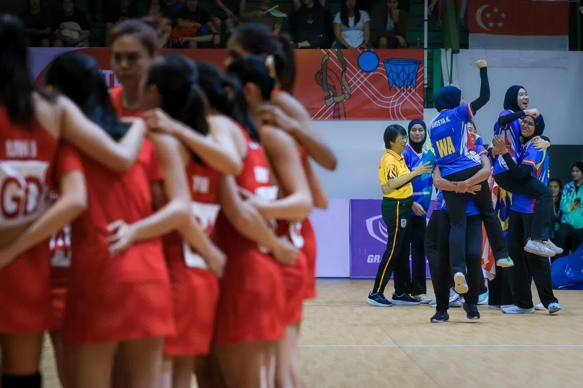 Singapore’s netball team (left) huddling after losing 52-49 to Malaysia in the final at the Chanthana Yingyong Gymnasium in Bangkok. The Malaysians celebrate a third consecutive gold while the Republic’s hunt for their first title since 2015 goes on.