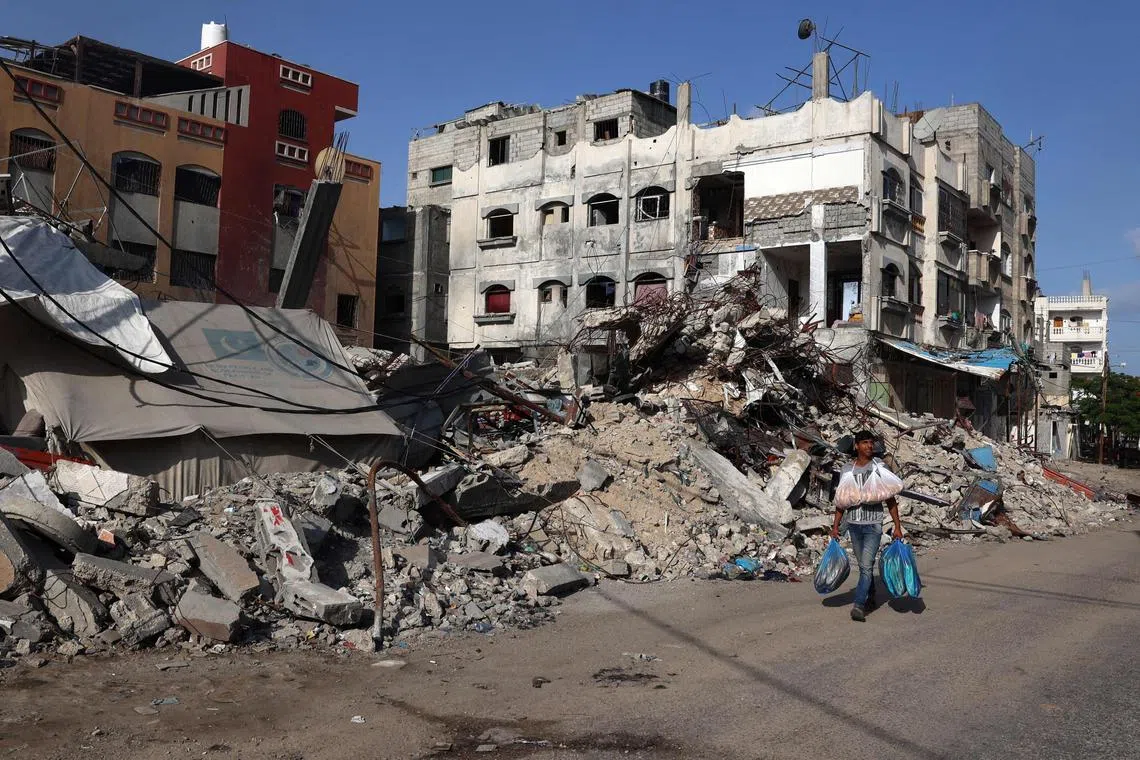 A Palestinian man walks past a destroyed building in Rafah in the southern Gaza Strip on May 26, 2024, amid the ongoing conflict between Israel and the Hamas militant group continues. (Photo by Eyad BABA / AFP)
