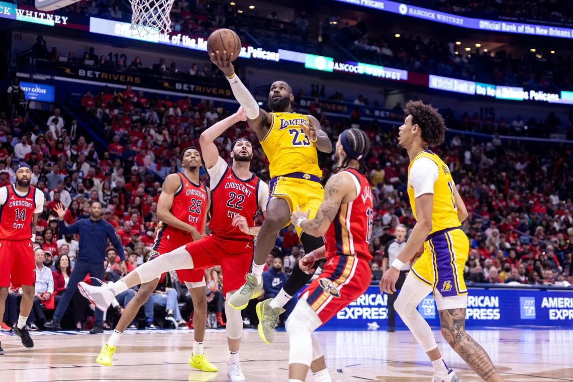 Los Angeles Lakers forward LeBron James drives to the basket against New Orleans Pelicans forward Larry Nance Jr. during the second half of the NBA play-in game at Smoothie King Centre.
