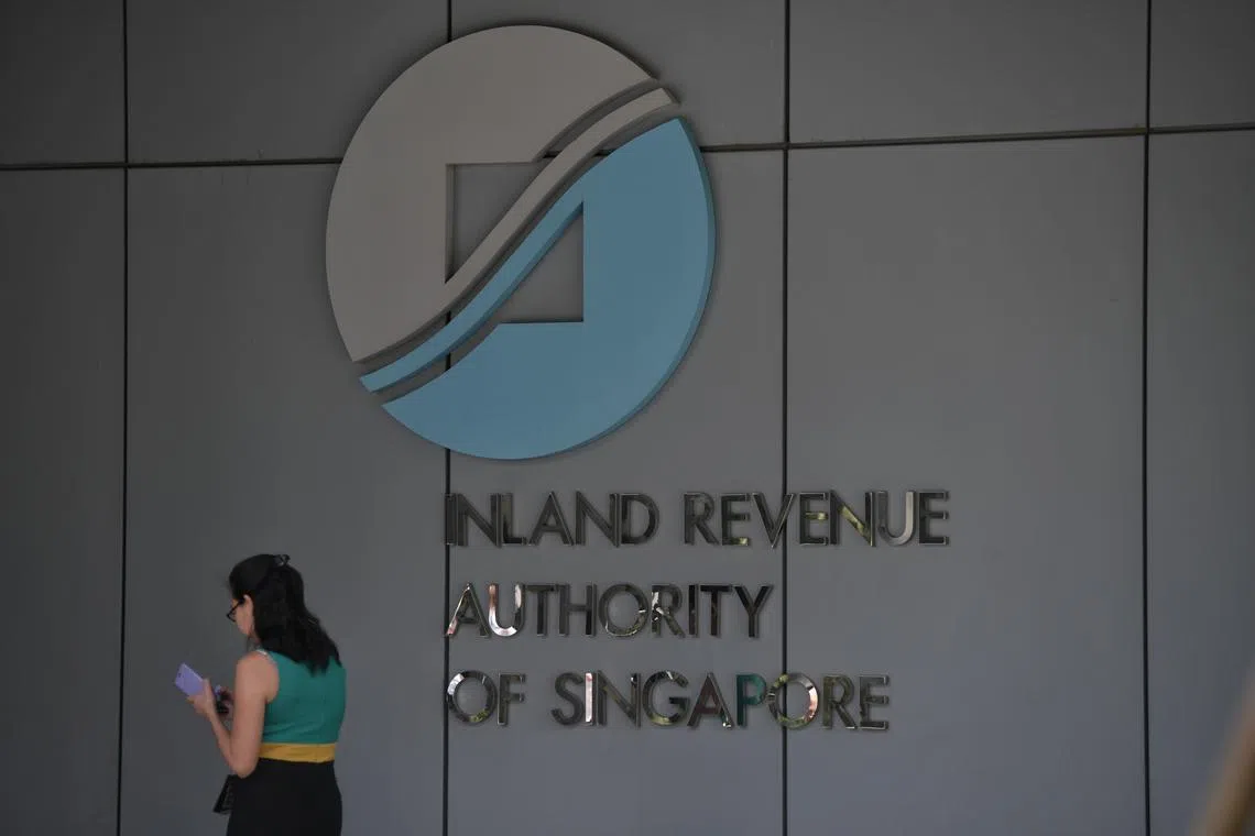 A lady walks past the IRAS logo on 17 September 2018.