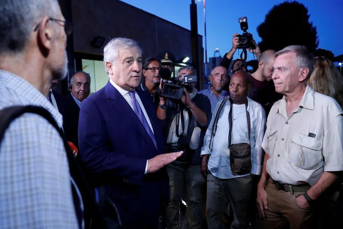 Italian Foreign Minister Antonio Tajani speaks with Italian nationals and other European and American citizens who have been evacuated from Niger, days after a junta seized power in the west African country, after they arrived at Ciampino Airport, near Rome, Italy, August 2, 2023. REUTERS/Remo Casilli