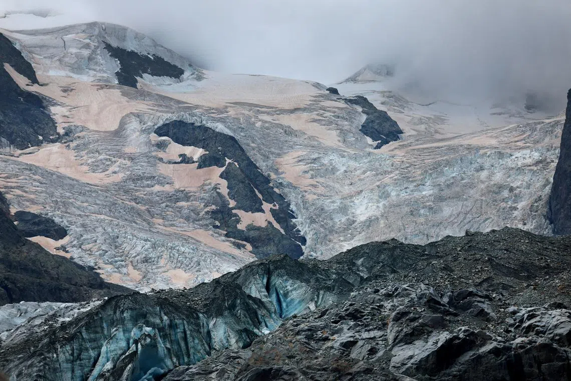 FILE PHOTO: Crevasses and Sahara dust are seen on the Morteratsch Glacier amid climate change, in Pontresina, Switzerland, September 3, 2024. REUTERS/Denis Balibouse/File Photo
