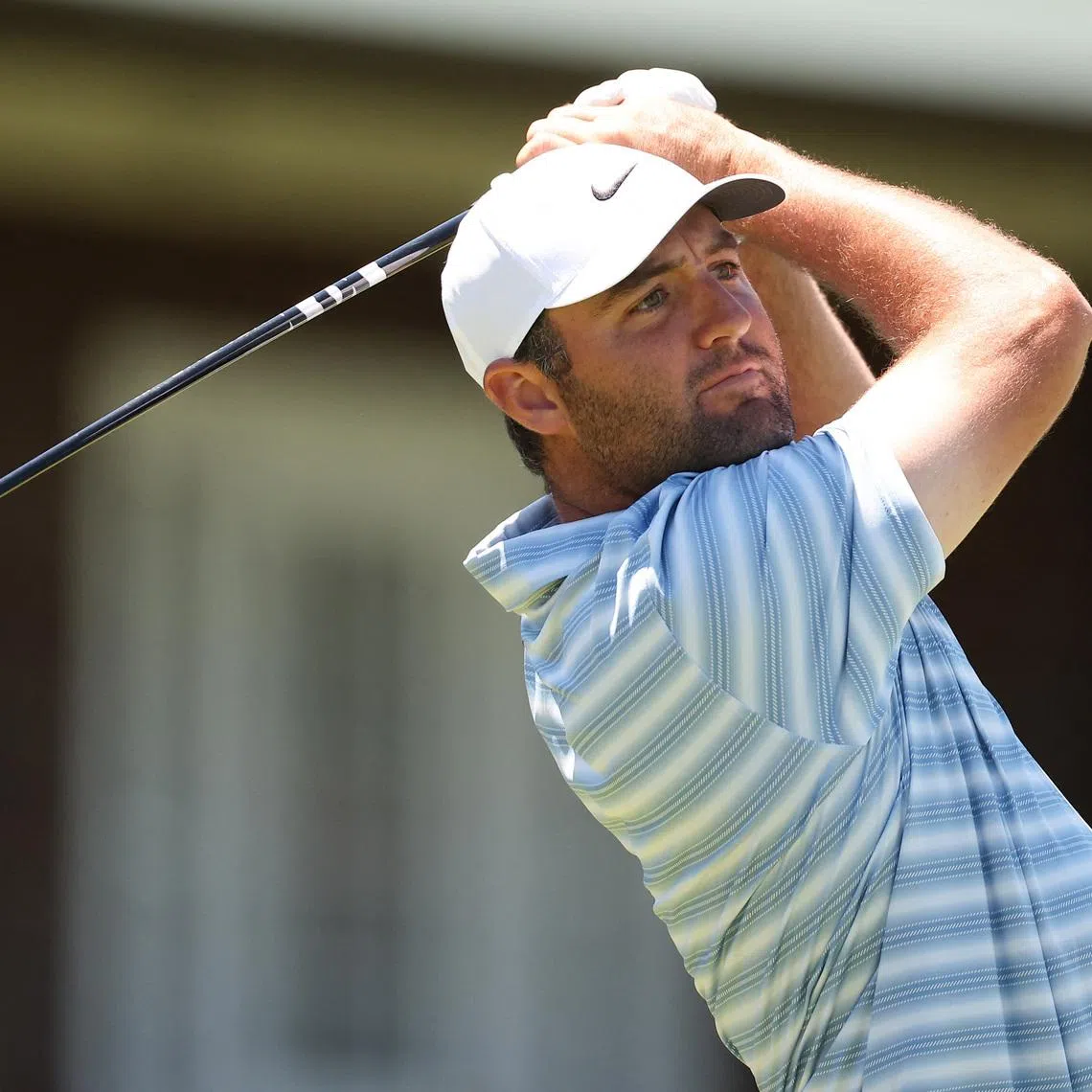Jun 15, 2026; Southampton, New York, USA; Scottie Scheffler plays a tee shot on hole 14 during a practice round for the U.S. Open golf tournament. Mandatory Credit: Bill Streicher-Imagn Images