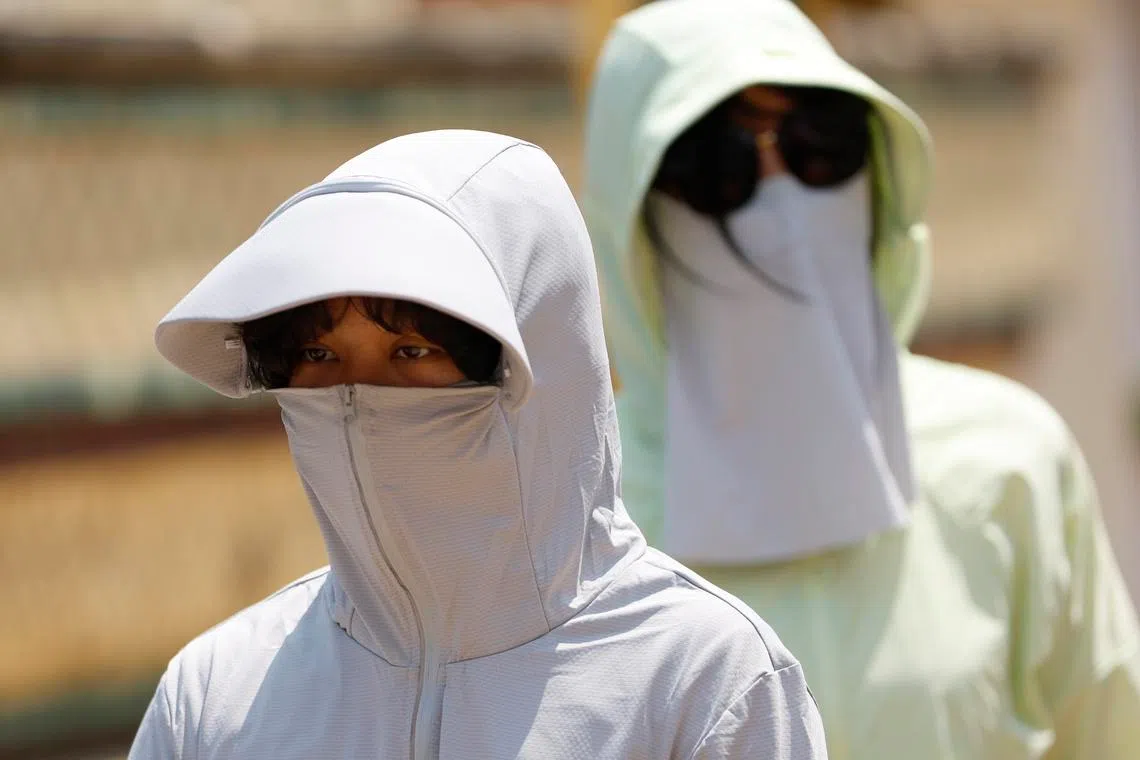 South-east Asia office workers swelter in energy-saving drive, heatwave