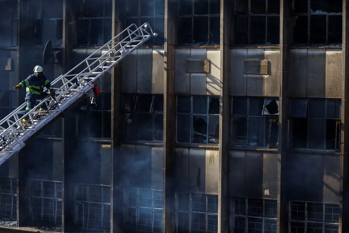 FILE PHOTO: A firefighter works at the scene of a deadly blaze, in Johannesburg, South Africa August 31, 2023. REUTERS/Siphiwe Sibeko