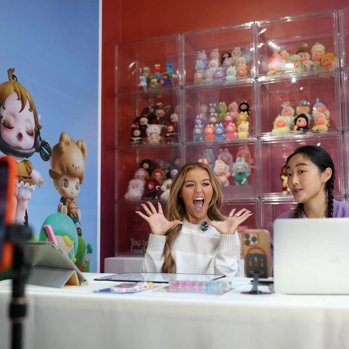 Influencer Anna Williams and Chinese actress Mary He during an AliExpress and Pop Mart livestream shopping show on Singles' Day at a pop-up store in London, Britain, on Nov 11. 