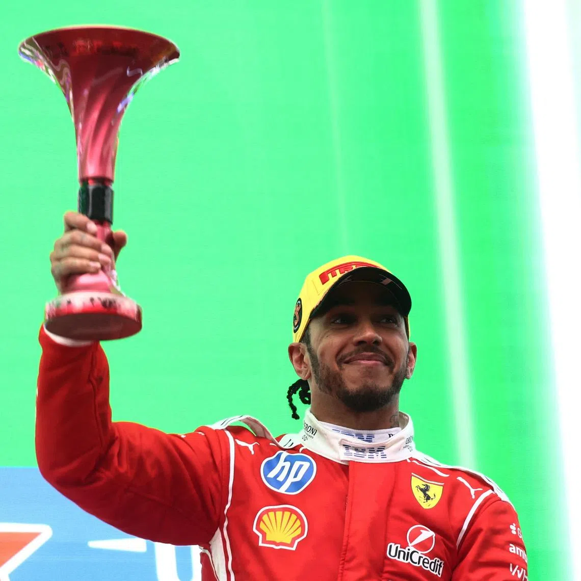 Formula One F1 - Chinese Grand Prix - Shanghai International Circuit, Shanghai, China - March 15, 2026 Ferrari's Lewis Hamilton celebrates with a trophy on the podium after finishing third place in the Chinese Grand Prix REUTERS/Jakub Porzycki