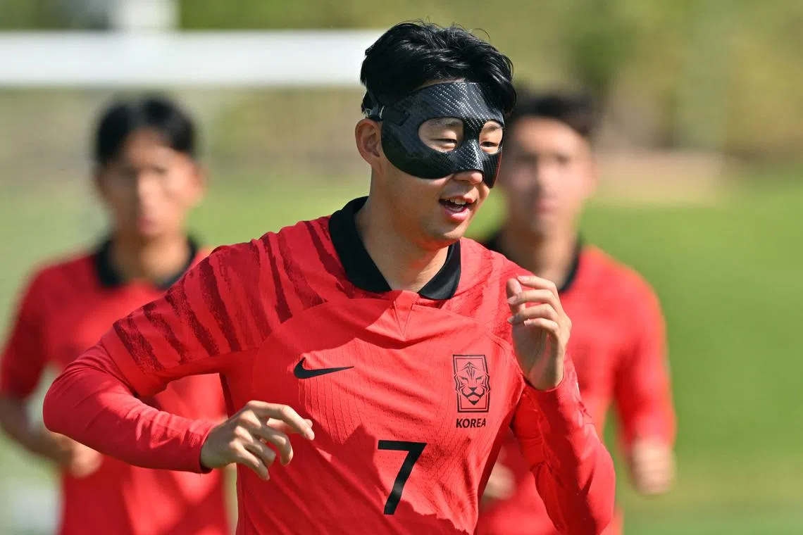 South Korea's Son Heung-min, who fractured his eye socket weeks ago, wearing a protective face mask during a training session at Al Egla Training Site 5 in Doha on Thursday. 