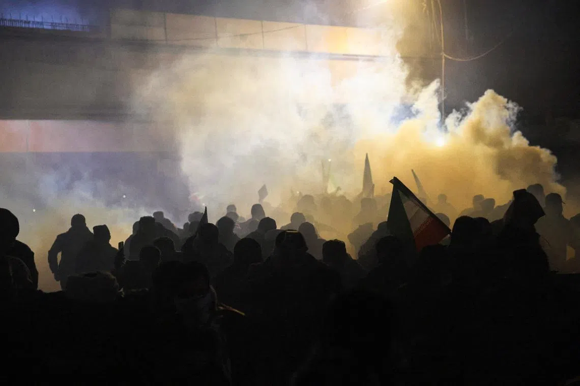 Protesters supporting Iraqi Shi'ite armed groups react to tear gas as they attempt to move toward the U.S. embassy located in Baghdad's Green Zone, as riot police deploy to block their advance, following the Israel and U.S. strikes on Iran and the killing of Iran's Supreme Leader Ayatollah Ali Khamenei, in Baghdad, Iraq, March 1, 2026. REUTERS/Ahmed Saad