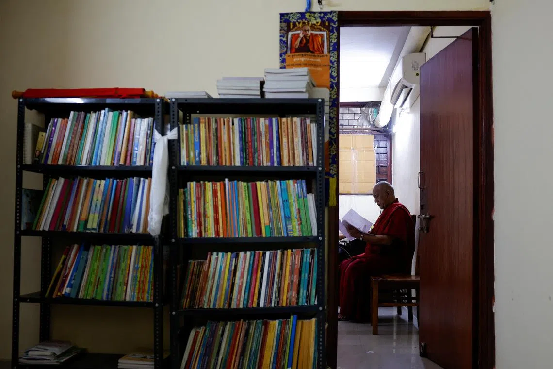 Lama Chosphel Zotpa, a monk and vice president of Indian Himalayan Council of Nalanda Buddhist Tradition (IHCNBT) reads a document at its office in New Delhi, India, March 13, 2025. REUTERS/Anushree Fadnavis
