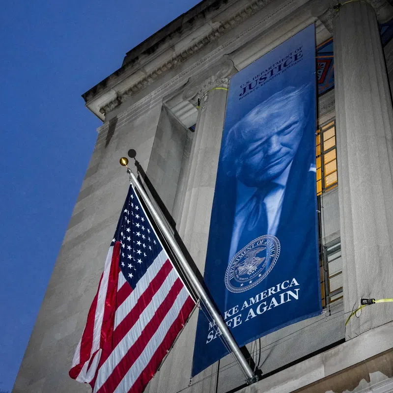 FILE PHOTO: A new banner depicting U.S. President Donald Trump is put up on the Department of Justice building in Washington, D.C., U.S., February 20, 2026.  REUTERS/Ken Cedeno/File Photo