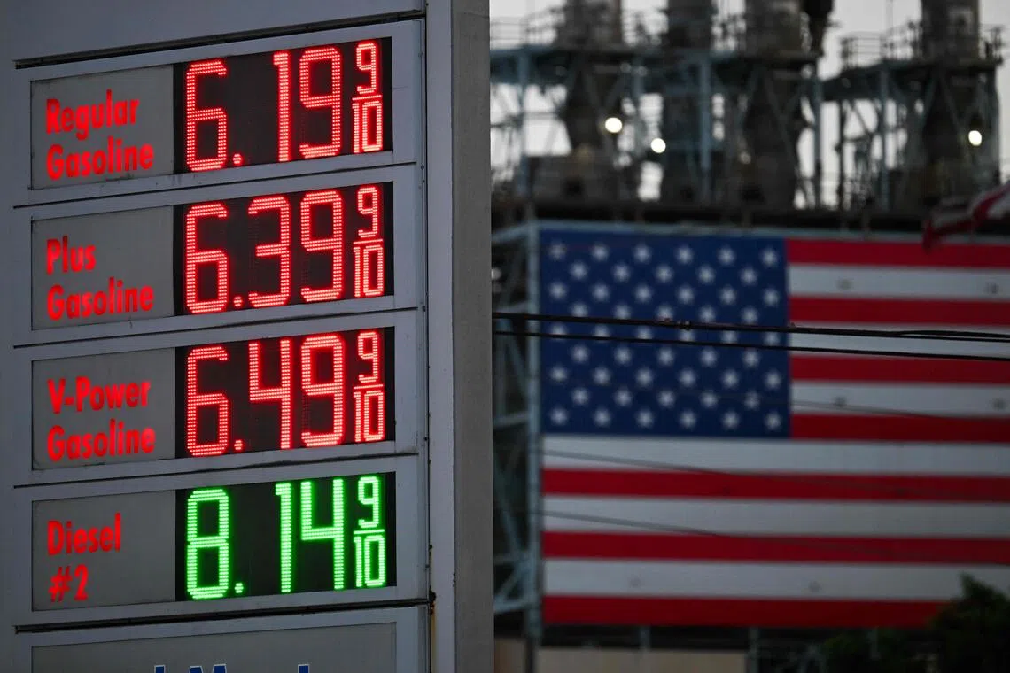 Fuel prices are displayed across from a US flag at a Shell station in Carson, California.