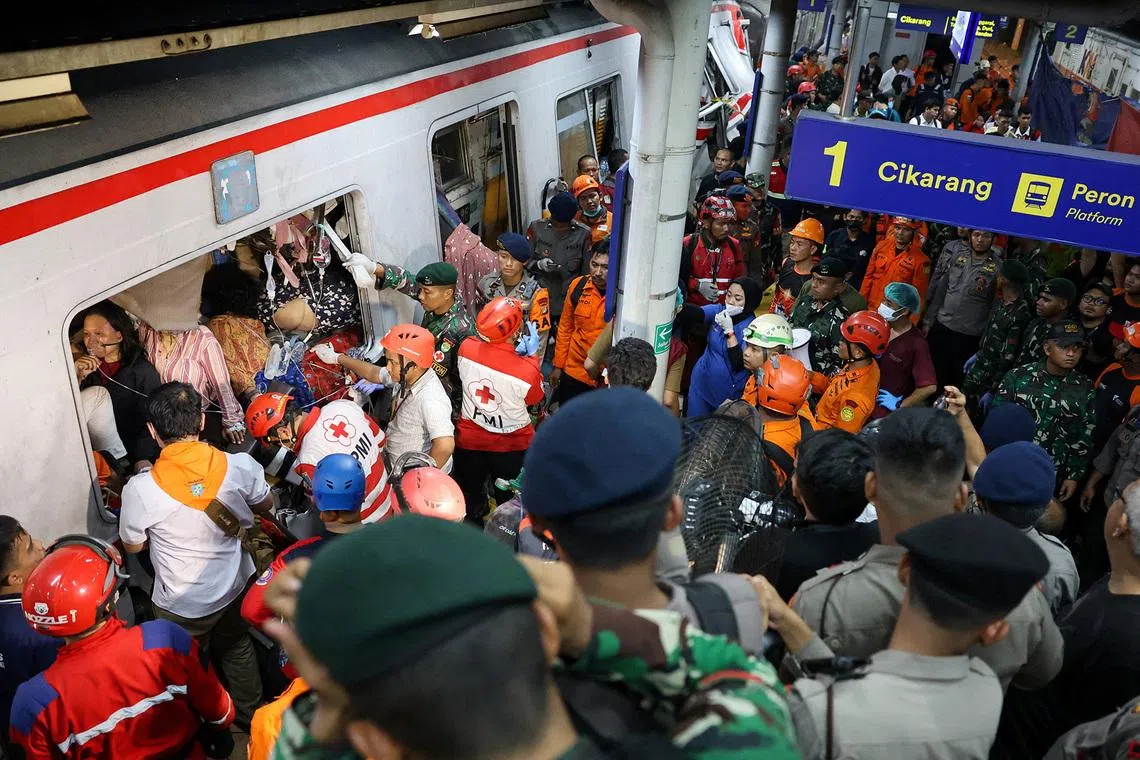 Emergency personnel racing to rescue passengers trapped in the damaged train.