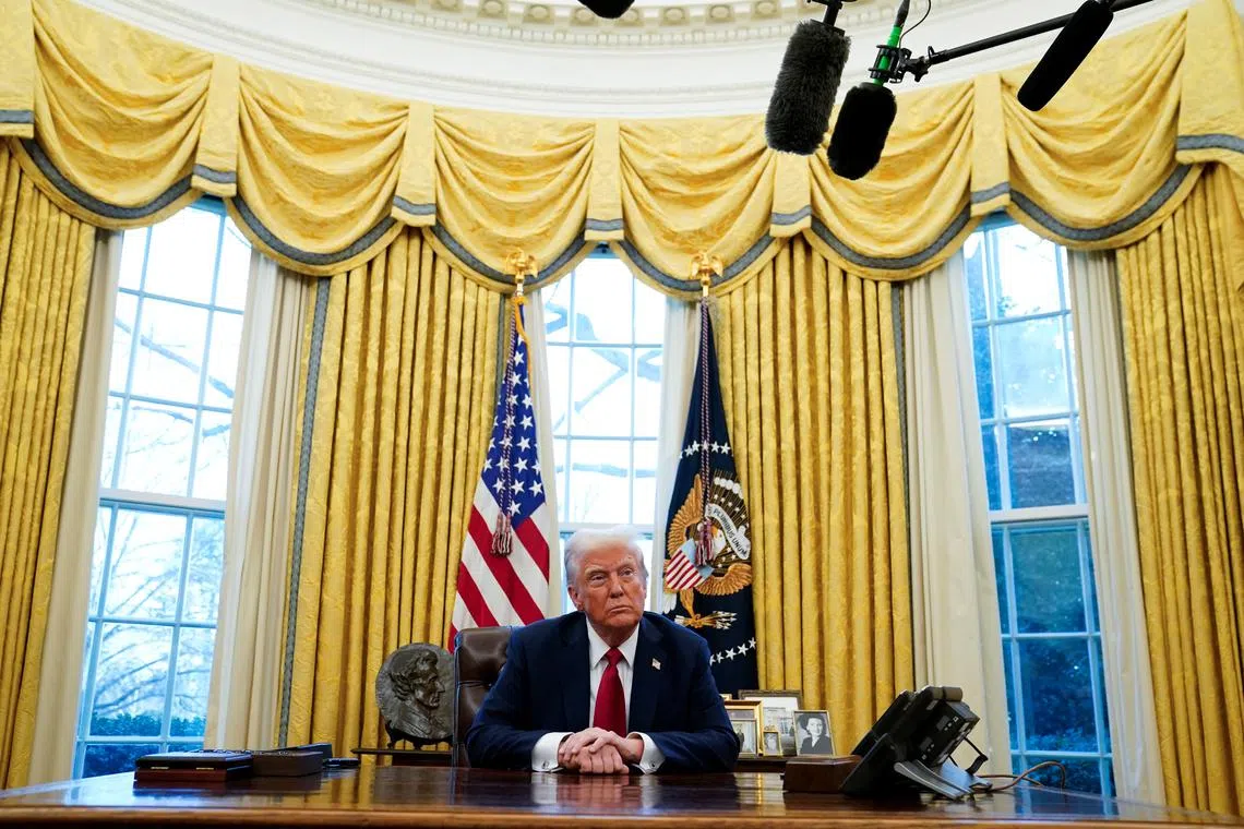 U.S. President Donald Trump sits at the Resolute Desk, where he signed executive orders during a brief event in the Oval Office at the White House in Washington, U.S., January 30, 2025. REUTERS/Elizabeth Frantz