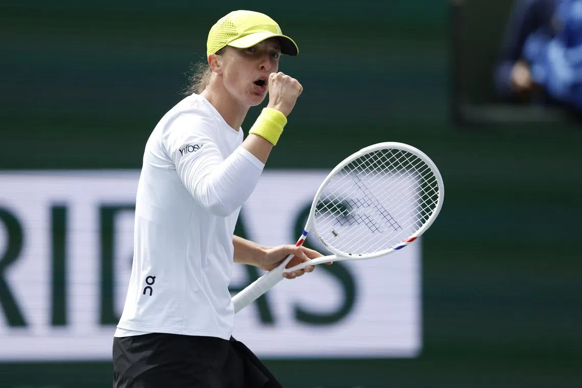 Poland's Iga Swiatek gesturing after winning a point against Qinwen Zheng of China on March 13.