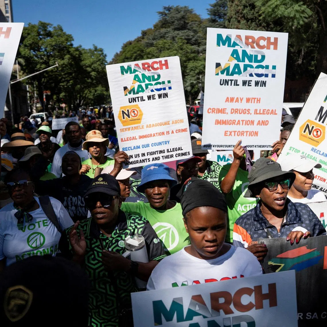 FILE PHOTO: Members of civil society groups and human rights organisations hold placards as they take part in a march calling for stronger government action against illegal immigration in Pretoria, South Africa, April 28, 2026. REUTERS/Ihsaan Haffejee/File Photo