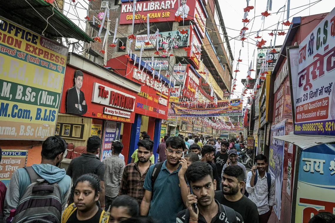 Students exit coaching classes in Patna, India on May 6, 2023. Thousands of students take preparatory classes in Patna, in the state of Bihar, for standardized tests for government jobs. Few will succeed. (Atul Loke/The New York Times)