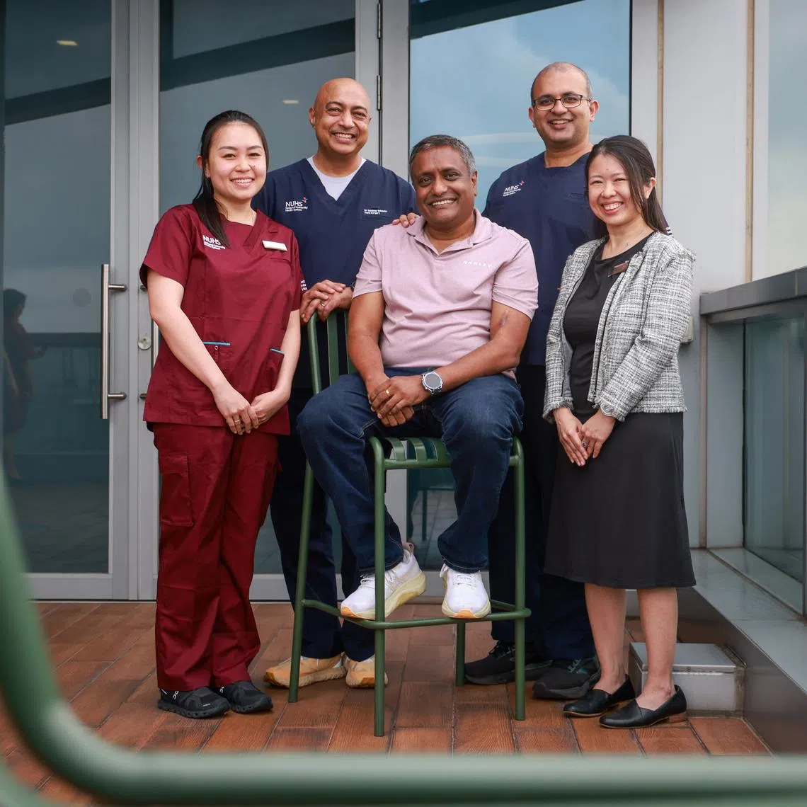 (From left) Senior Physiotherapist of NUH's Department of Rehabilitation Karilyn Koh; Head & Senior Consultant of NUH's Department of Hand & Reconstructive Microsurgery Sandeep Jacob Sebastin Muttath; NUH patient Patrick Pereira; director of NUH Centre for Trauma Raj Menon; Head of Division & Senior Consultant, Division of General Surgery (Trauma), of NUH's Department of Surgery Lynette Loo.