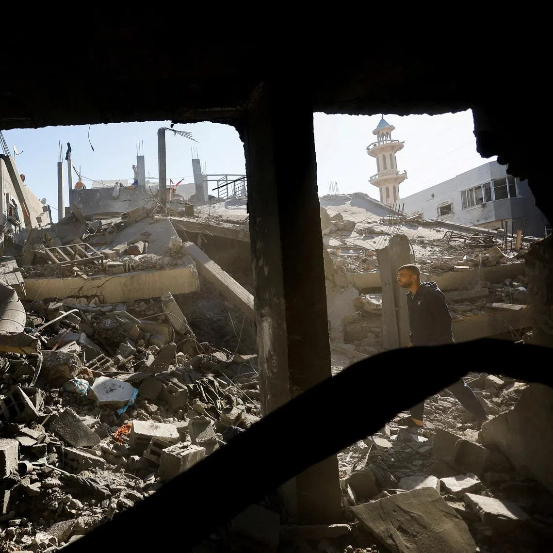 A Palestinian man inspects the site of an Israeli strike on a house whose residents were warned to evacuate before the attack, in Zawayda, central Gaza Strip June 5, 2026. REUTERS/Mahmoud Issa