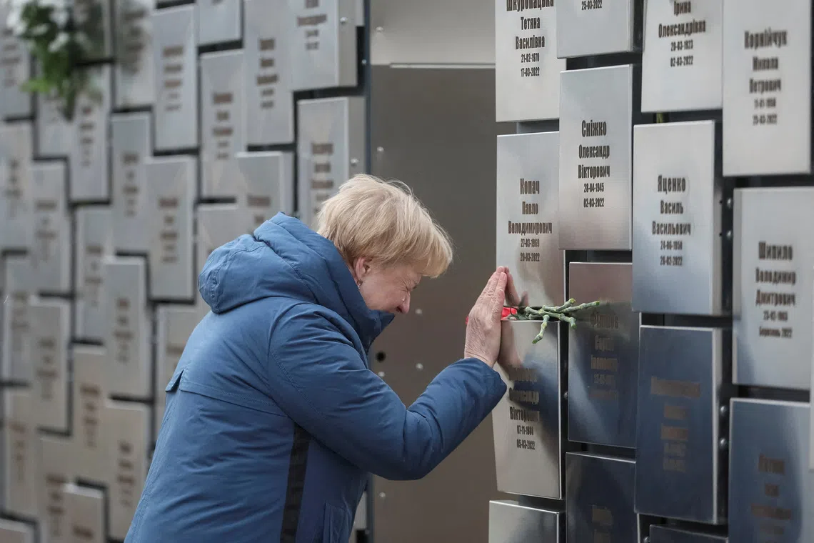 FILE PHOTO: A woman visits the memorial to the victims of the Russian occupation, marking the third anniversary of the liberation of the town of Bucha during Russia's attack on Ukraine, in Bucha, near Kyiv, Ukraine, March 30, 2025. REUTERS/Gleb Garanich/File Photo