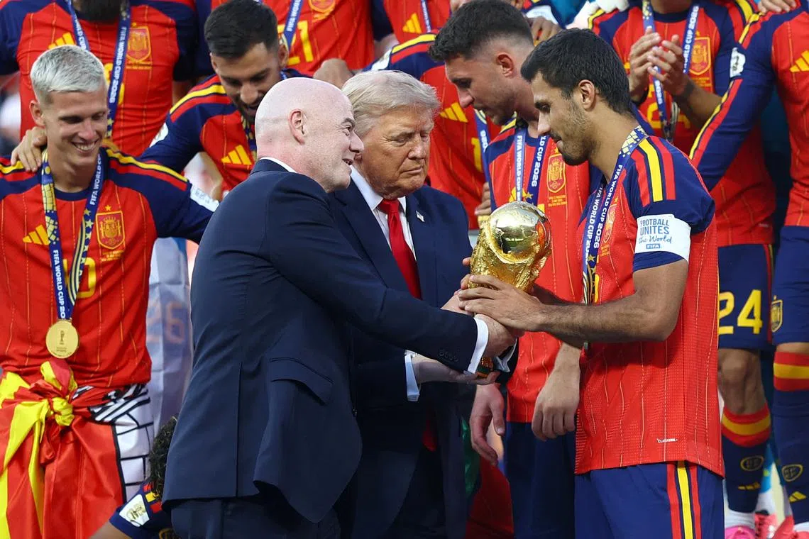 FIFA president Gianni Infantino (left) and US President Donald Trump (centre) hands the World Cup trophy to Spain’s Rodri ahead of the trophy lift.