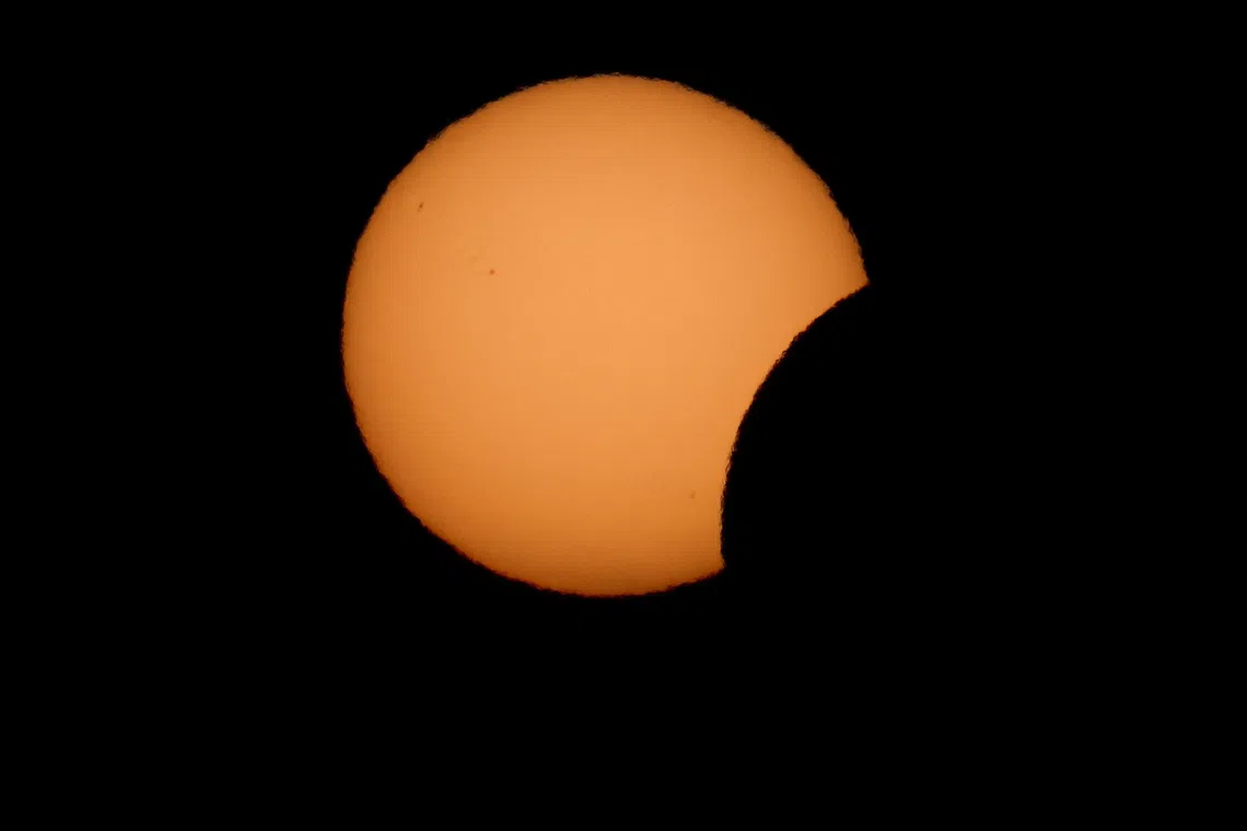The moon partially covers the sun during a solar eclipse, in Piran, Slovenia, August 12, 2026. REUTERS/Borut Zivulovic