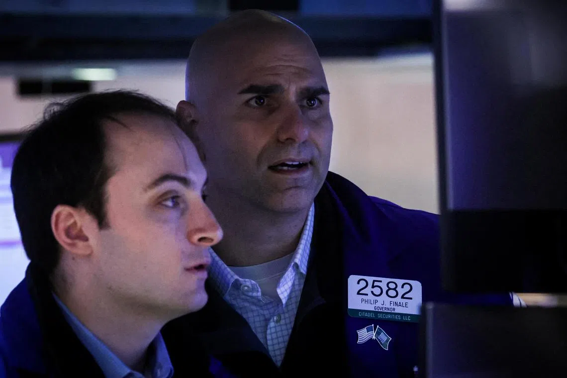 Traders work on the floor of the New York Stock Exchange, in New York City. 