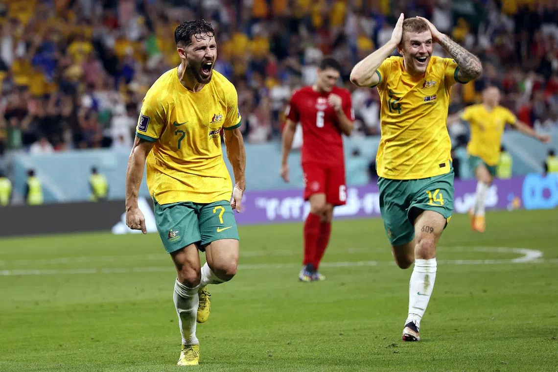 Australia's Mathew Leckie (left) celebrates with teammate Riley McGree after scoring in the 1-0 win over Denmark in their final Group D match on Wednesday. They will meet the Group C winners in the round of 16.