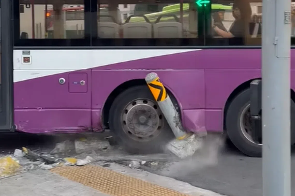 Video footage of the incident shows the left side of a double-decker bus mounted on the corner of a kerb, with a bollard lodged in one of the vehicle’s rear wheels.