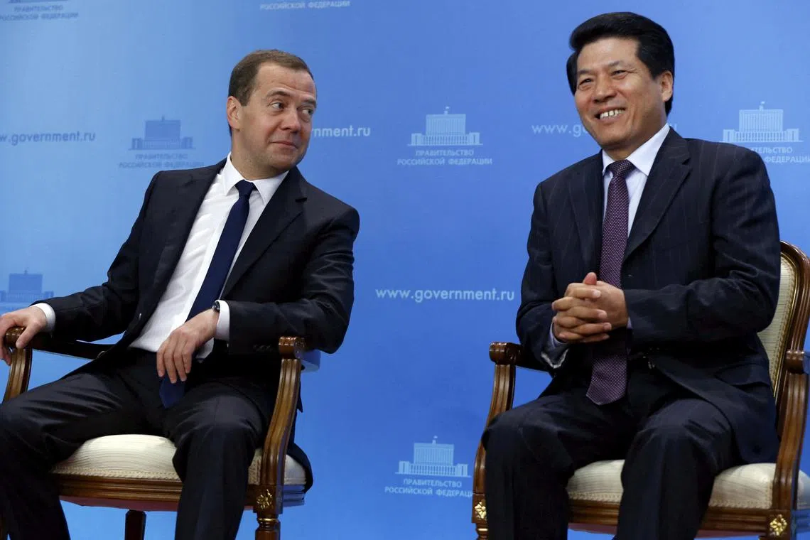 Mr Li Hui, China's special representative for Eurasian affairs, (R) sat with Russian Prime Minister Dmitry Medvedev (L)  during his time as ambassador to Moscow. 
