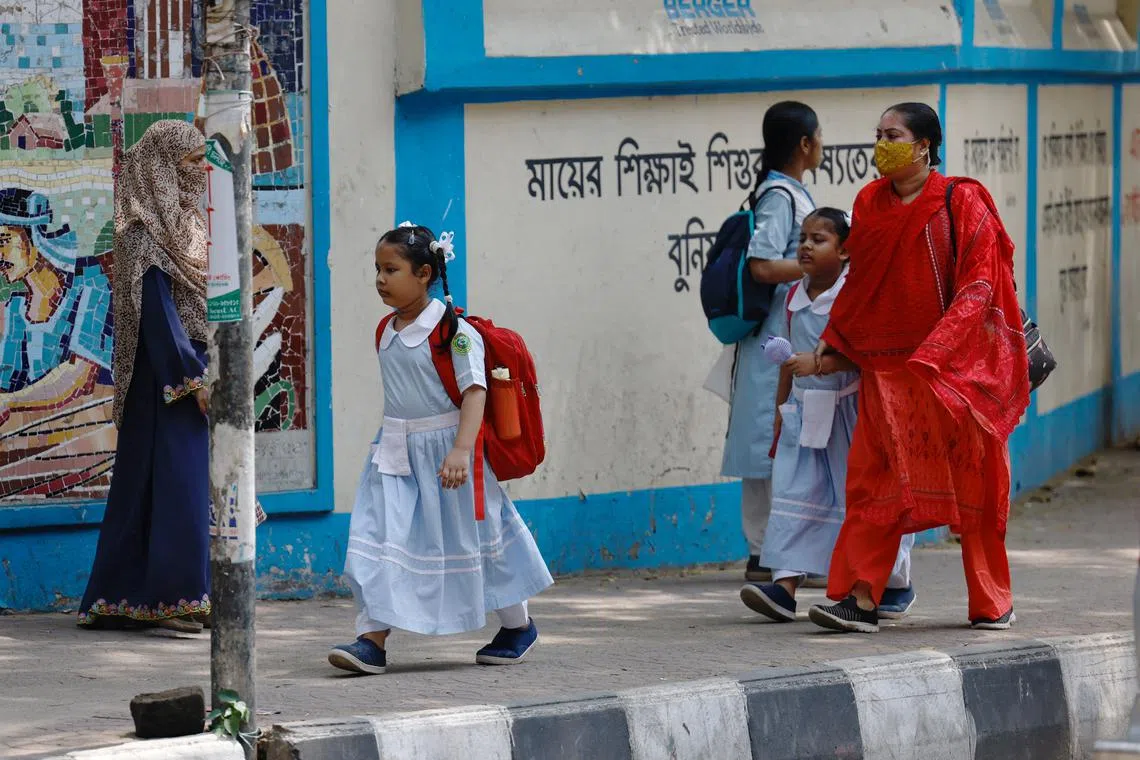 Children go to school as schools reopen after the fall in temperature, in Dhaka, Bangladesh, May 5, 2024. REUTERS/Mohammad Ponir Hossain