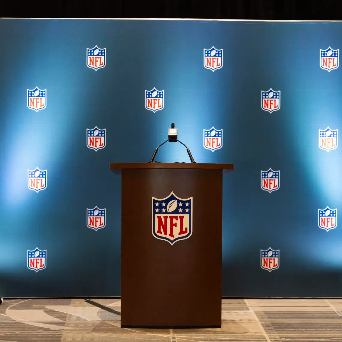 Mar 30, 2026; Phoenix, AZ, USA; Detailed view of the NFL shield logo on a lectern in a press conference room during the 2026 NFL Annual League Meeting at the Arizona Biltmore. Mandatory Credit: Mark J. Rebilas-Imagn Images