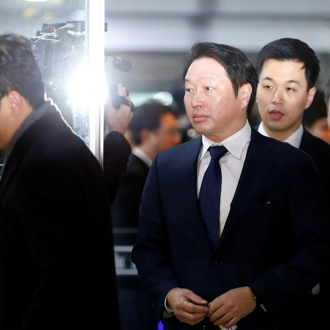 SK Group Chairman Chey Tae-won arrives to attend a hearing at the National Assembly in Seoul, South Korea, December 6, 2016.  REUTERS/Kim Hong-Ji