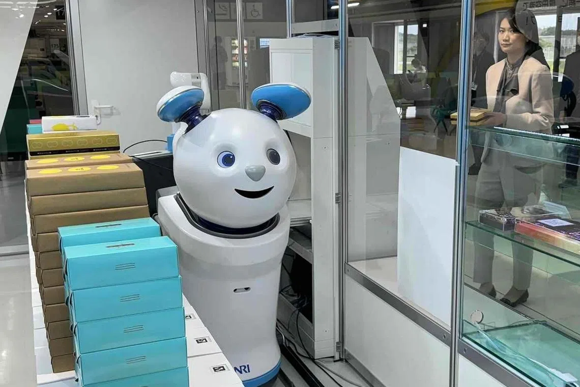 A robot is selling merchandise as part of a trial run at an unstaffed souvenir store at Narita Airport.