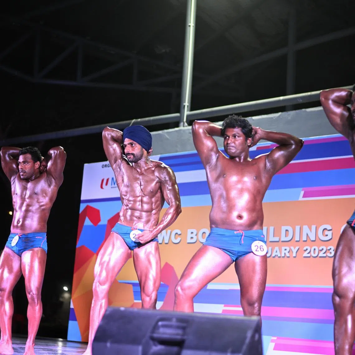 Participants preening and posing during the Migrant Workers' Centre Bodybuilding Championship at Migrant Workers' Centre Recreation Club on Feb 26, 2023.
