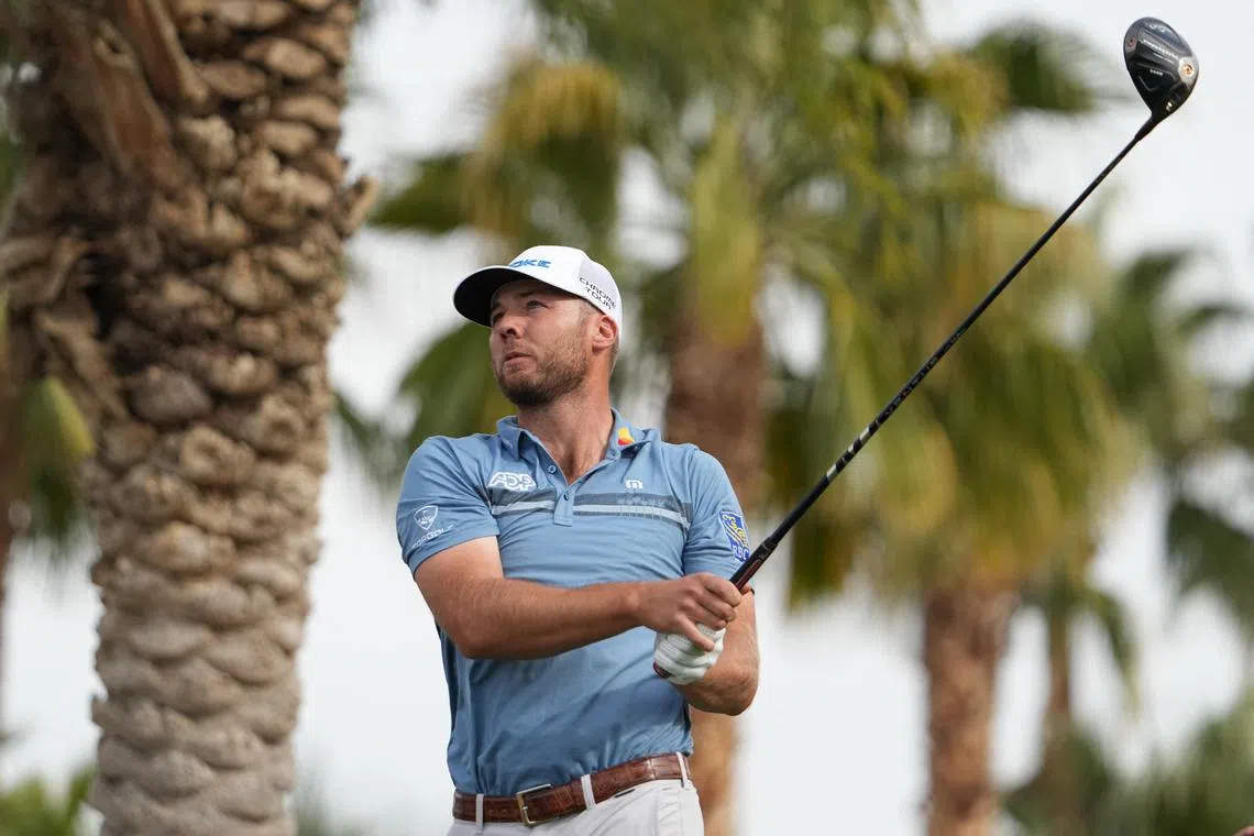 Sam Burns hits his tee shot on the 18th hole during the second round of the American Express golf tournament.