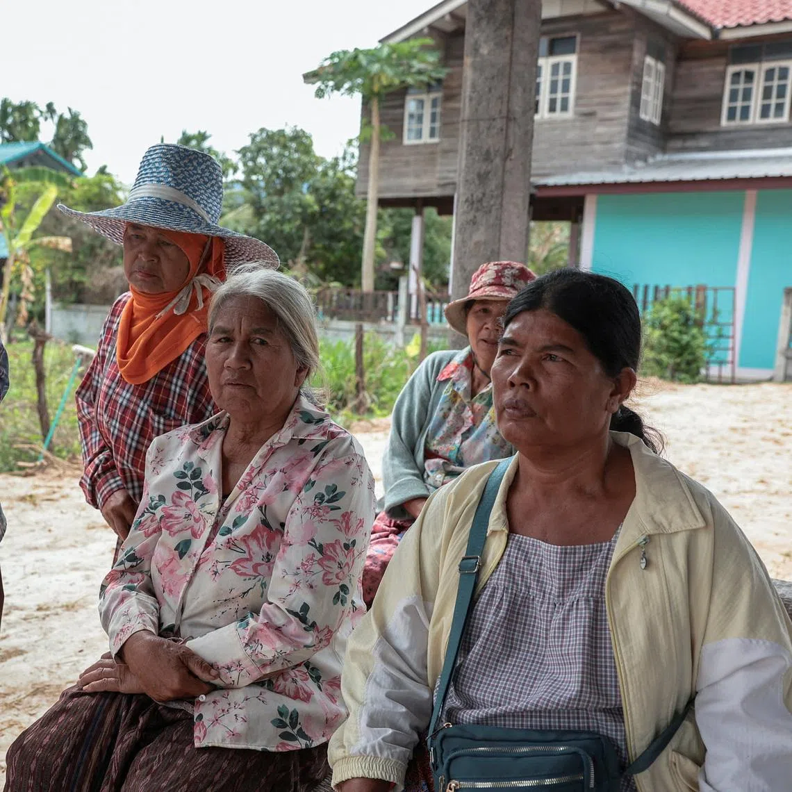Ms Sommai Butdee (right) with her relatives and friends as they wait for news of her nephew, a crew member missing from the Thai-flagged vessel that was struck with projectiles earlier this week.