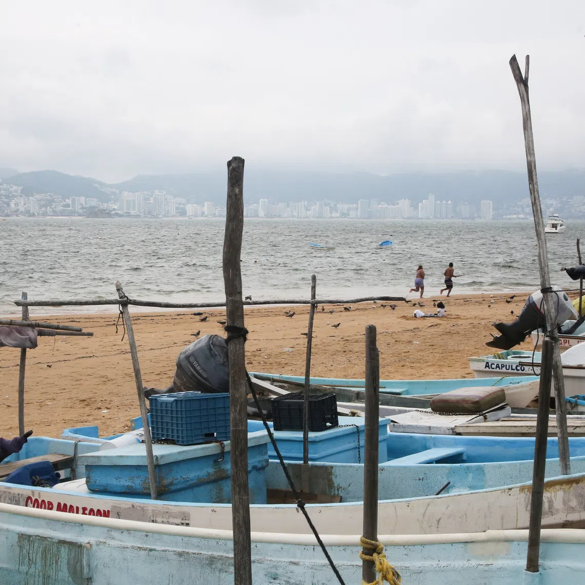 Fishing boats rest on the sand after being pulled from the sea as Hurricane Trudy moves parallel to Mexico's Pacific coast, threatening more rain and strong winds after recent deadly storms, in Acapulco, Mexico, October 15, 2026. REUTERS/Javier Verdin