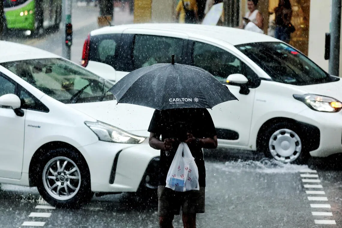 ST20260717_202646400617 Kelvin Chng pixgeneric/People out with raincoats and umbrella shielding from the rain, taken at Chinatown area on July 17, 2026.// use for wet weather , rainy, rain, Rainy weather pictures for wet weather story, Thundery showers are expected on most days over Singapore. Showers are expected Photo Opportunities: pixgeneric/People out with raincoats and umbrella shielding from the rain, taken at Chinatown area on July 17, 2026.// use for wet weather , rainy, rain, Rainy wea