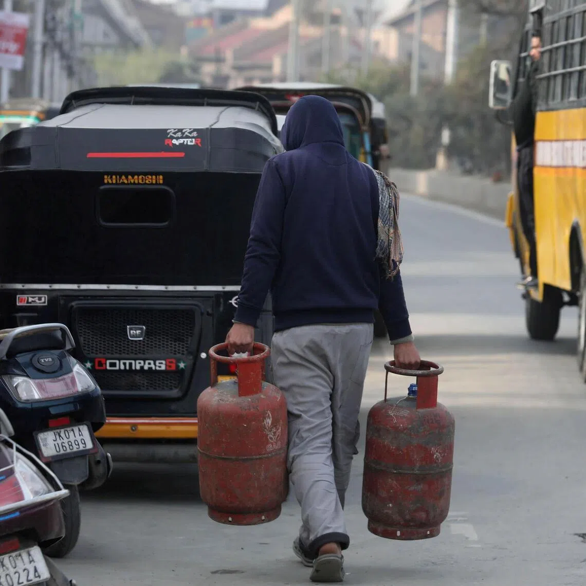 A man brings empty household cylinders of liquefied petroleum gas to be refilled to an authorised dealer in Srinagar, Kashmir, India, March 14, 2026. 