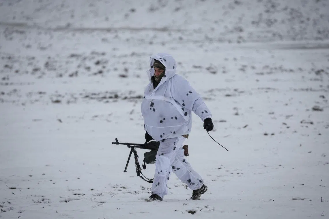 A Ukrainian serviceman attends a joint drills of armed forces, national guard and Security Service of Ukraine (SBU) near the border with Belarus, amid Russia's attack on Ukraine in Rivne region, Ukraine January 11, 2023. 
