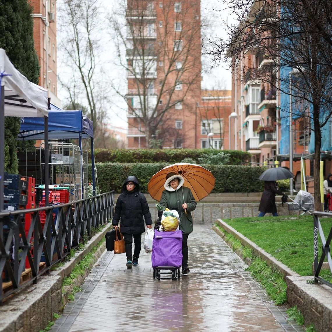 A woman and a baby walk in Madrid, Spain.