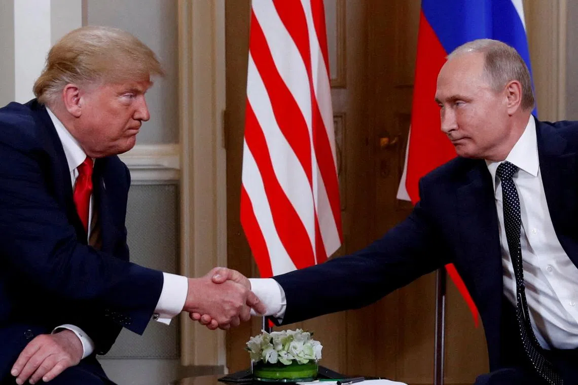US President Donald Trump and Russian President Vladimir Putin shake hands as they meet in Helsinki, in July 2018.