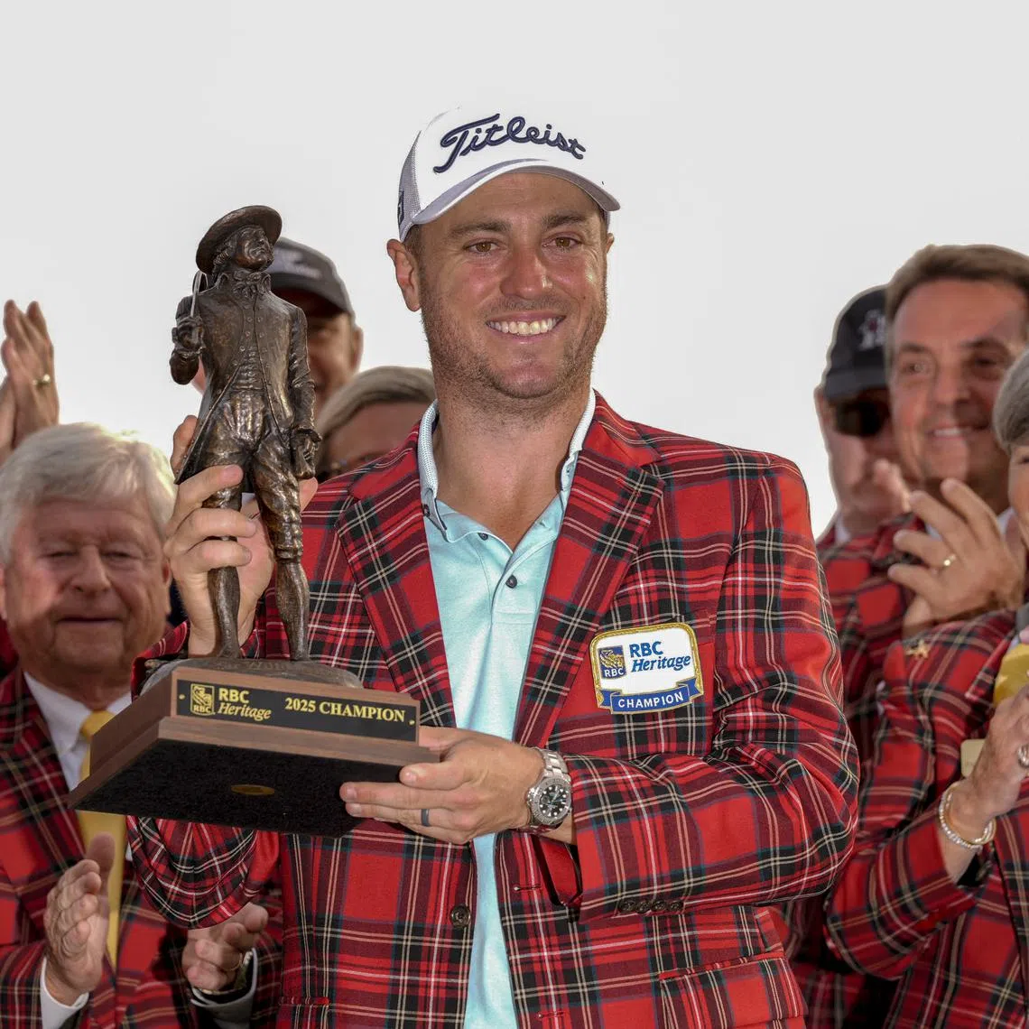 Apr 20, 2025; Hilton Head, South Carolina, USA; Justin Thomas holds his trophy and wears the plaid jacket after winning the final round of the RBC Heritage golf tournament. Mandatory Credit: Jim Dedmon-Imagn Images