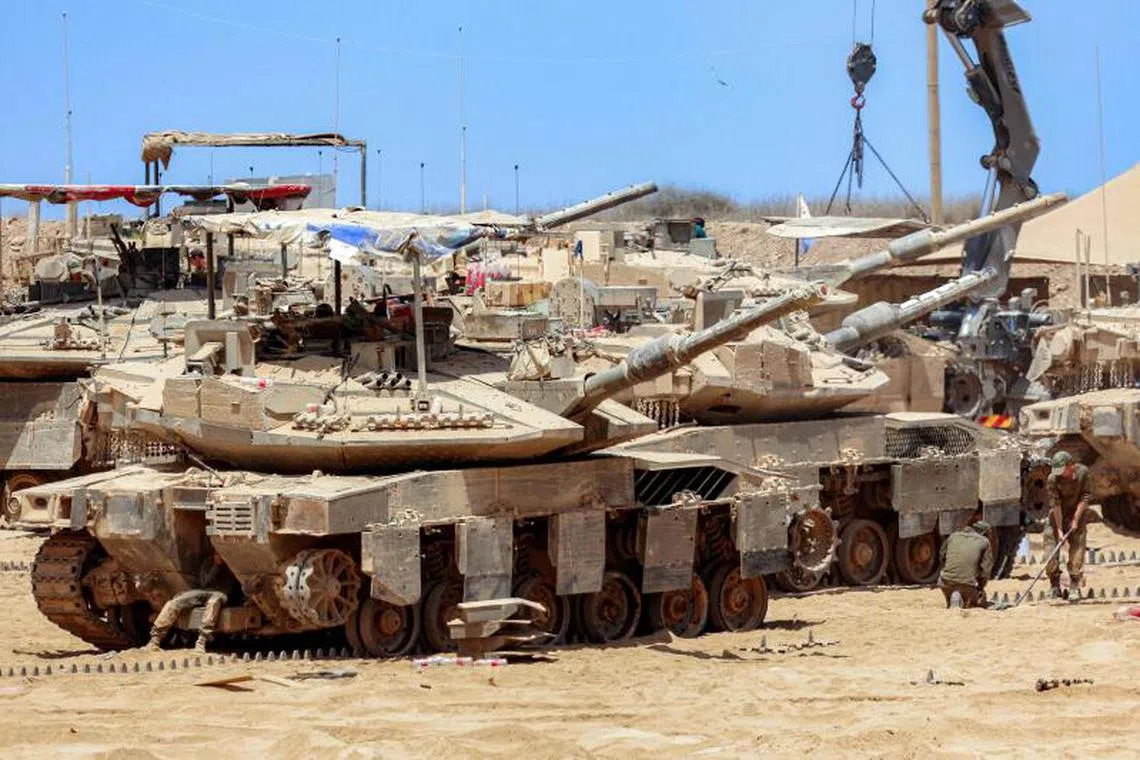 Israeli army battle tanks positioned near the border with the Gaza Strip in southern Israel on Aug 5, 2025.