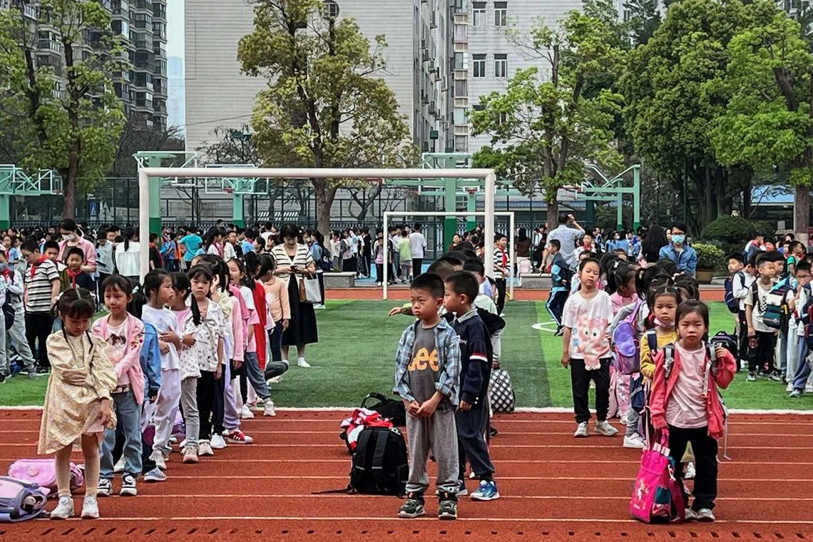 TOPSHOT - Students evacuate to the playground at a school in Xiamen, in eastern China's Fujian province on April 3, 2024, after a major earthquake hit Taiwan's east. At least four people were killed and nearly 60 injured on April 3 by a powerful earthquake in Taiwan that damaged dozens of buildings and prompted tsunami warnings that extended to Japan and the Philippines before being lifted. (Photo by AFP) / China OUT