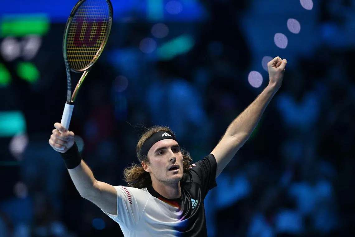 Stefanos Tsitsipas celebrates after beating Daniil Medvedev in the round-robin stage of the ATP Finals.